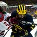 Michigan freshman center Justin Selman competes for a puck on the boards in the game against Miami on Saturday, March 23. Daniel Brenner I AnnArbor.com